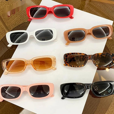 Children's small frame oval sunglasses with a solid white PC frame and brown AC lenses for UV protection. - Image 4