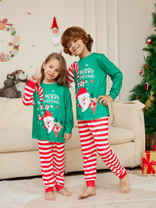Family of four wearing matching green Christmas pajamas with Santa, reindeer, and red striped pants. - Image 3
