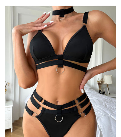 Woman wearing a royal blue strappy lingerie set with O-rings, including a bra, high-waisted bottoms, and a choker. - Image 11