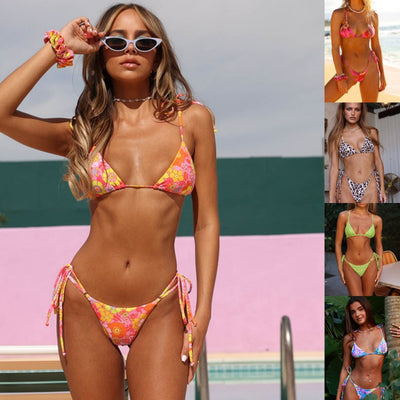 Vibrant floral print bikini set with tie-side triangle top and matching bottoms, featuring pink, blue, orange, and purple flowers.