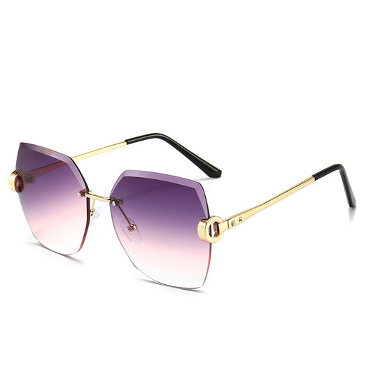 Woman wearing oversized hexagonal rimless sunglasses with gradient lenses and a black leather newsboy cap. - Image 10
