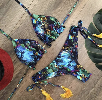 Women's tropical floral print bikini with a halter top, ruffled edges, and tie-side bottoms with pink tassels. - Image 27