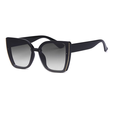 Women's black cat-eye sunglasses with large frames, gradient gray lenses, and gold-tone accents. - Image 6