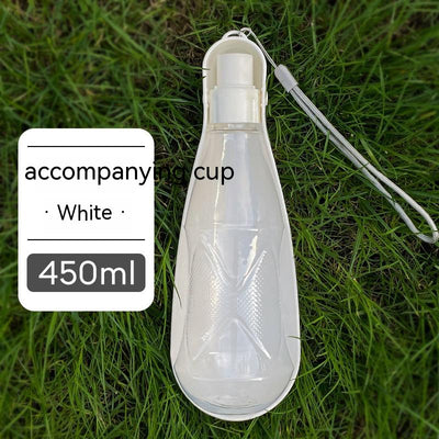 Yellow 450ml portable pet water bottle with a folding drinking trough and white wrist strap, on grass. - Image 10