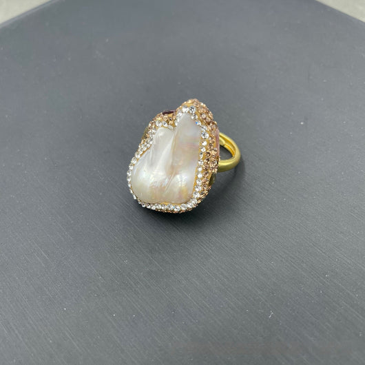 Gold-toned ring with a large, irregularly shaped white freshwater pearl centerpiece, framed by clear and champagne rhinestones. - Image 7