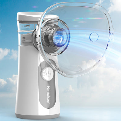 White and blue handheld ultrasonic nebulizer with a clear mask, emitting a blue light, against a bright blue sky.