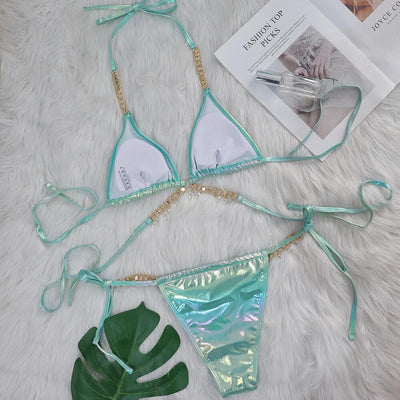 Iridescent purple and pink two-piece bikini with gold-toned crystal embellishments on a white faux fur background. - Image 20