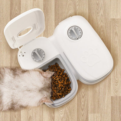 White automatic pet feeder with a pink timer dial and an embossed paw print on the lid. - Image 6