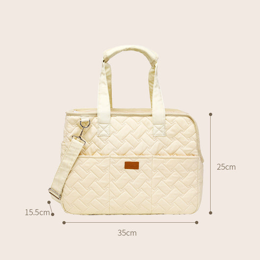 Cream quilted portable pet carrier with top handles, detachable shoulder strap, front pocket, and ventilation mesh. - Image 3