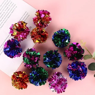 Five iridescent crinkle paper balls, likely cat toys, arranged in a circle on a peach background. - Image 13