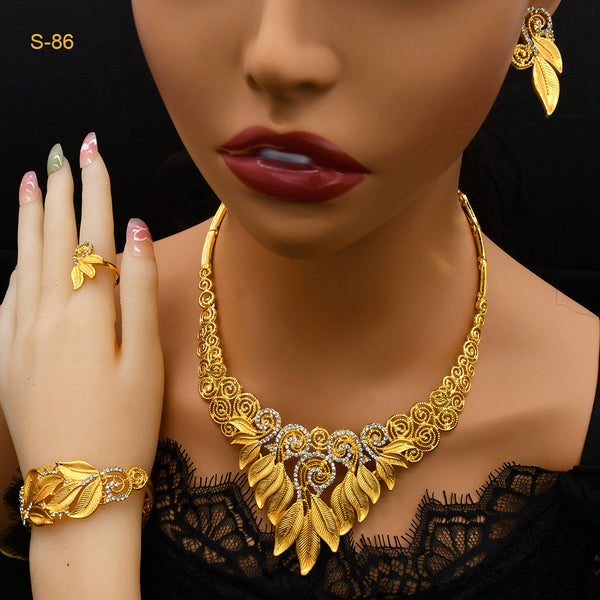 Women's Saudi bridal four-piece gold-colored jewelry set with floral and leaf designs, featuring a necklace, bracelet, earrings, and ring.