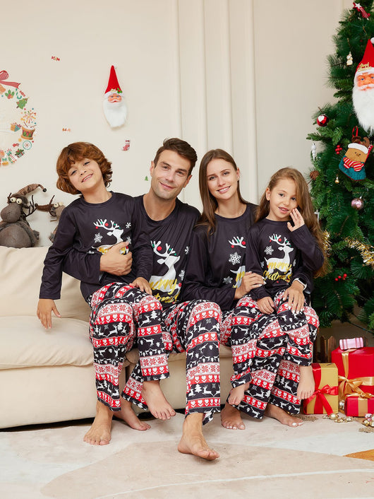 Two children wearing black long-sleeve Christmas pajamas with a "Merry Christmas" reindeer design and fair isle pants. - Image 3