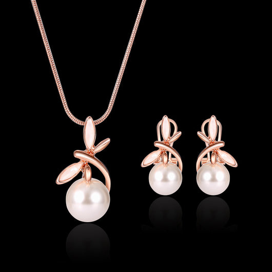 Rose gold-toned necklace and matching earrings set with white pearls and a delicate floral or leaf design. - Image 9