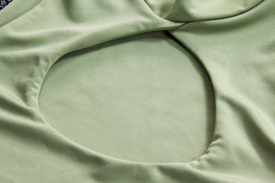 Light green two-piece set featuring a sleeveless crop top with a high neck and chest cutout, paired with a ruched bodycon mini skirt. - Image 16