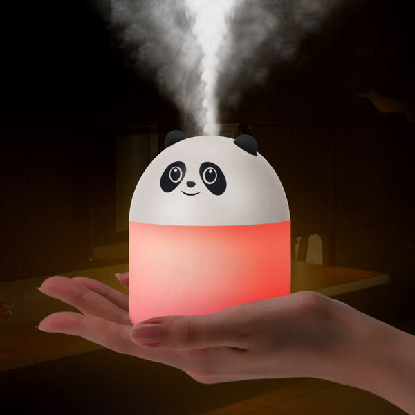 Panda-shaped humidifier and aromatherapy machine emitting mist, glowing red, held in a hand.