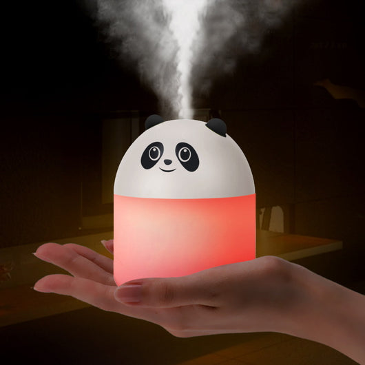 Panda-shaped humidifier and aromatherapy machine emitting mist, glowing red, held in a hand.
