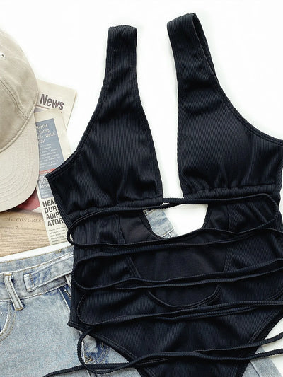 White ribbed one-piece swimsuit with deep V-neck, hollow cut-outs, and criss-cross tie straps. - Image 14