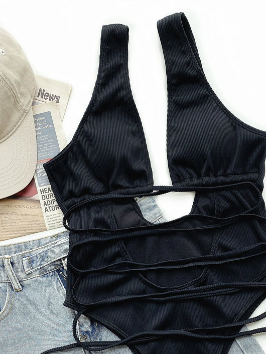 White ribbed one-piece swimsuit with deep V-neck, hollow cut-outs, and criss-cross tie straps. - Image 14