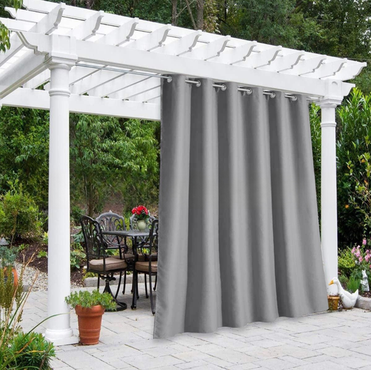 Solid gray outdoor curtain panels with grommet tops hanging from a white pergola on a sunny patio. - Image 5