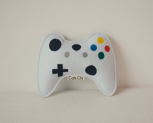 Light blue felt catnip toy shaped like a game controller with piano keys and a black string for hanging. - Image 14