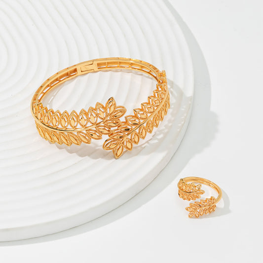 Gold wheat ear leaf cuff bracelet and matching open ring set on a white textured surface. - Image 2