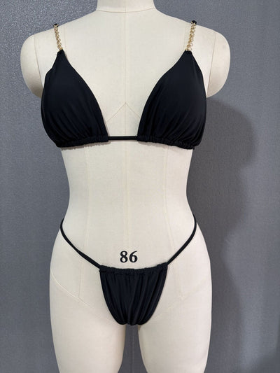 White three-point bikini with gold chain straps on a mannequin, featuring a triangle top and thong bottom. - Image 25