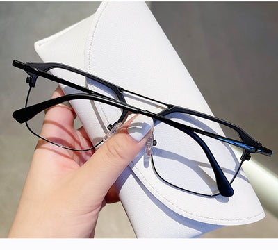 Anti-blue light glasses with a sand black and silver double beam frame, held against a white case. - Image 19