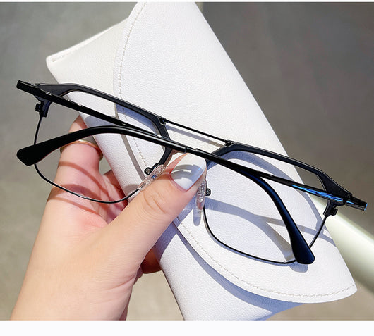 Anti-blue light glasses with a sand black and silver double beam frame, held against a white case. - Image 19