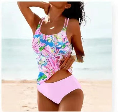 Woman wearing a red retro split high waist tankini swimsuit with an ornate mandala print top on a beach. - Image 9