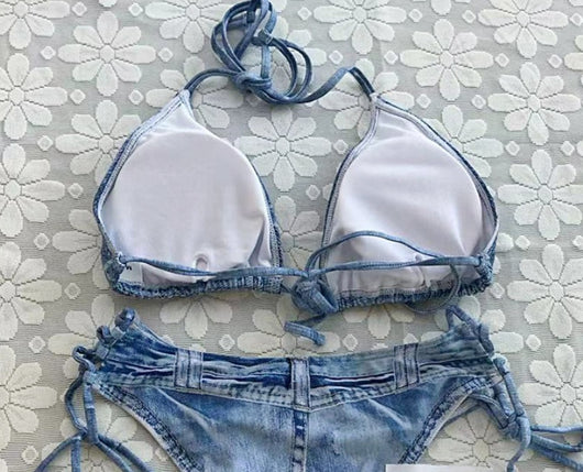 Women's light blue denim print two-piece bikini swimsuit with a halter neck top and tie-side bottoms, styled with a straw hat and sunglasses. - Image 16