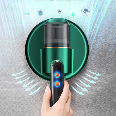 Dark blue handheld bed vacuum cleaner with clear dustbin, gold accents, and illuminated control panel on a charging base.