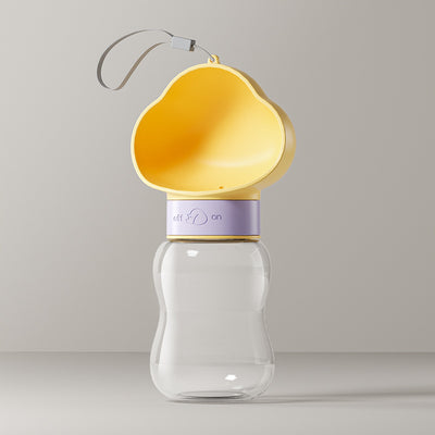 Yellow and clear portable pet water bottle with integrated drinking bowl and separate food container for walking dogs. - Image 9