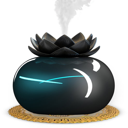 Black spherical aromatherapy humidifier with a lotus flower top, emitting mist, sitting on a gold decorative doily. - Image 2