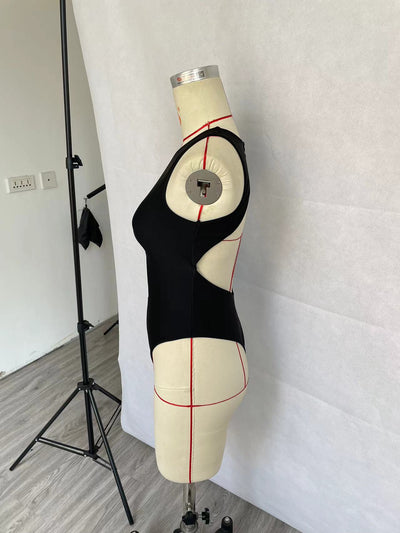 Women's black one-piece swimsuit with a high neck, chest cut-out, and rhinestone embellishment, modeled in a pool. - Image 12