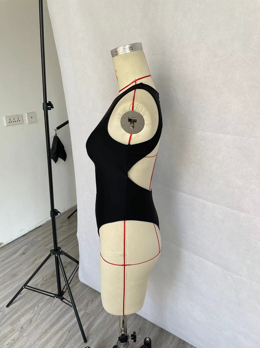 Women's black one-piece swimsuit with a high neck, chest cut-out, and rhinestone embellishment, modeled in a pool. - Image 12
