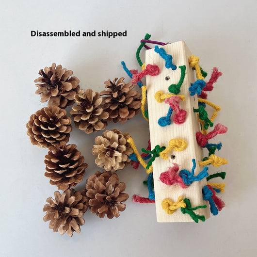 Packaged parrot toy with a wooden block, colorful hemp ropes, and natural pine cones for chewing and play. - Image 11