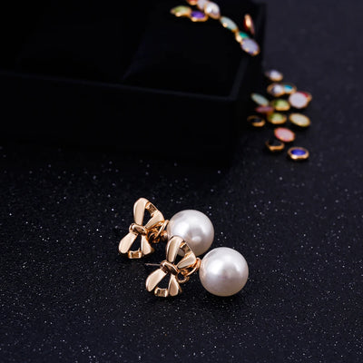 Aretes Elegantes de Corazón con Moño de Circonia y Perla - Image 11