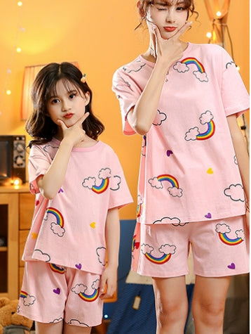 Mother and daughter wearing matching pink cotton short-sleeved pajama sets with rainbow and cloud patterns. - Image 3
