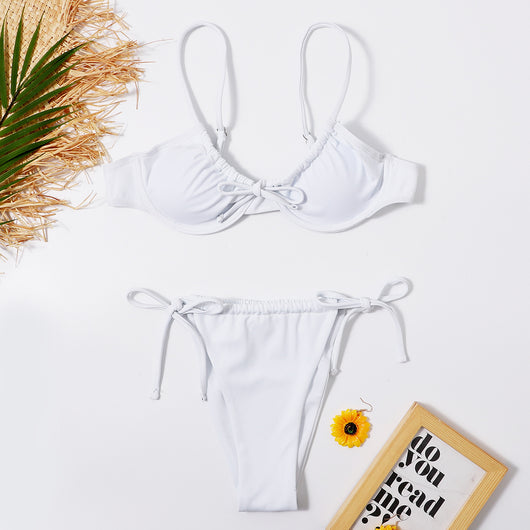 White two-piece underwire swimsuit with a front tie bikini top and adjustable string bottoms, displayed flat.