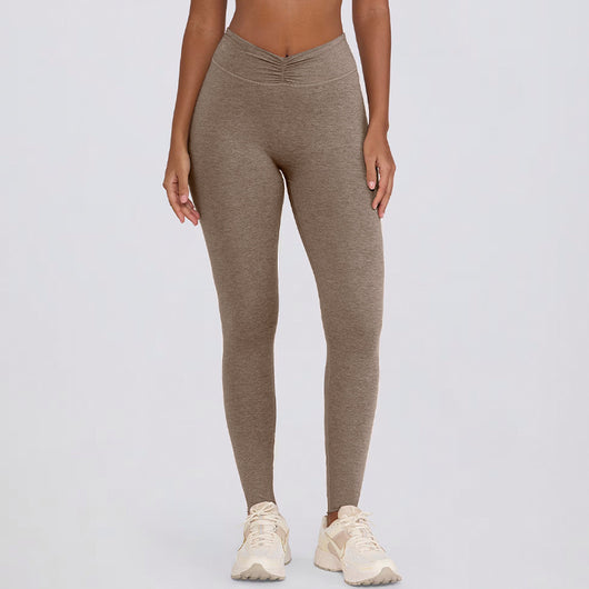 Light pink halter neck sports bra and high-waisted leggings workout set on a model. - Image 17