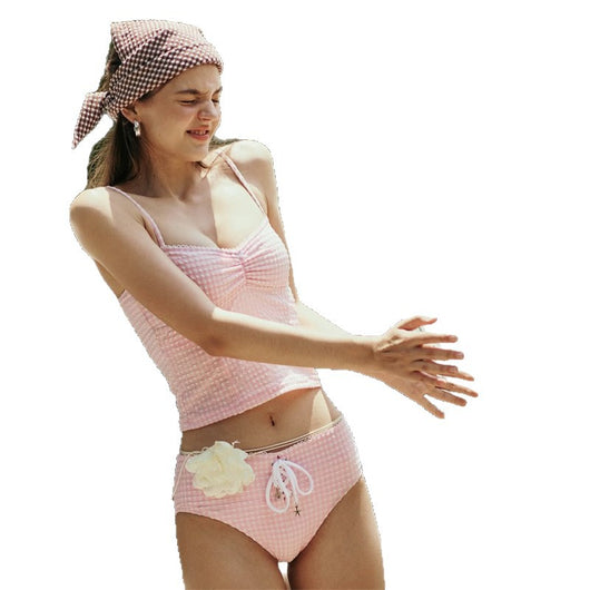 Woman in a blue and brown plaid two-piece swimsuit with a matching headscarf and sunglasses, holding a fluffy object. - Image 5
