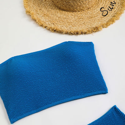 Blue high-waisted bikini set with a textured bandeau top and high-cut bottoms, laid flat on white. - Image 25