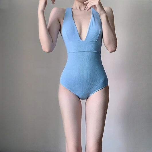 Light blue ribbed one-piece swimsuit with a deep V-neck and halter straps, modeled on a person. - Image 4