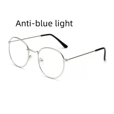 Retro oval anti-blue light glasses with a dark metal frame and clear lenses on a white background. - Image 7