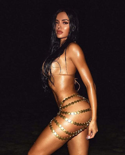 Copper halter bikini top and bottom with a gold beaded skirt, laid flat with sunglasses, seashell, and flowers. - Image 17