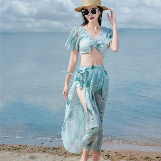 Women's light blue tropical leaf print three-piece swimsuit with short sleeve bikini top, bottoms, and sarong skirt. - Image 20