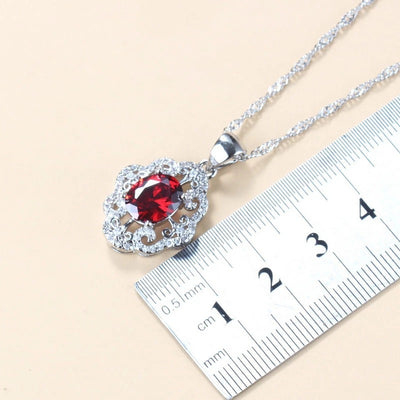 Four-piece jewelry set with silver-tone settings, featuring oval purple cubic zirconia stones surrounded by clear accents. - Image 3