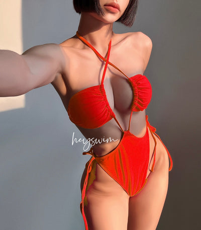 Black drawstring one-piece swimsuit with a ruched halter top and high-cut, tie-side bottom on a woman. - Image 5
