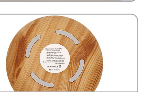 Teardrop-shaped aromatherapy humidifier with light wood grain finish, emitting mist and glowing with purple LED light. - Image 8