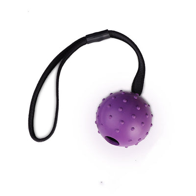 Red rubber dog training ball with nubs and a black rope handle, designed for bite resistance and molar cleaning. - Image 10